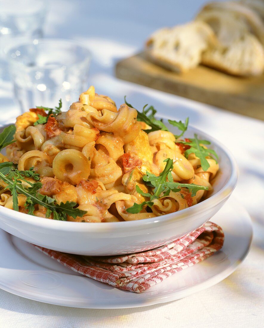 Pasta with tomato cream sauce, bacon, chicken and rocket