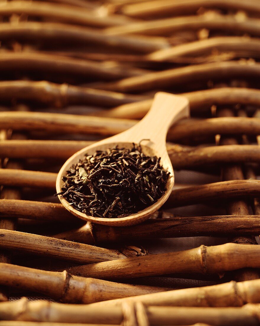 Black tea mixture on wooden tea measuring spoon