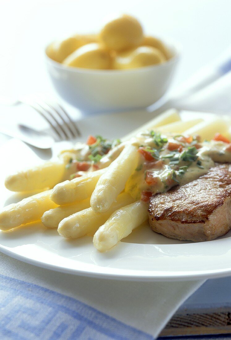 White asparagus with sauce and fried veal fillet