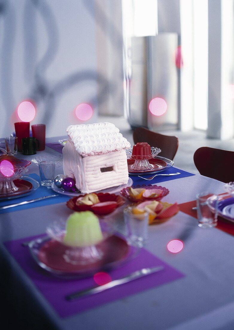 Table laid for Christmas with candy houses