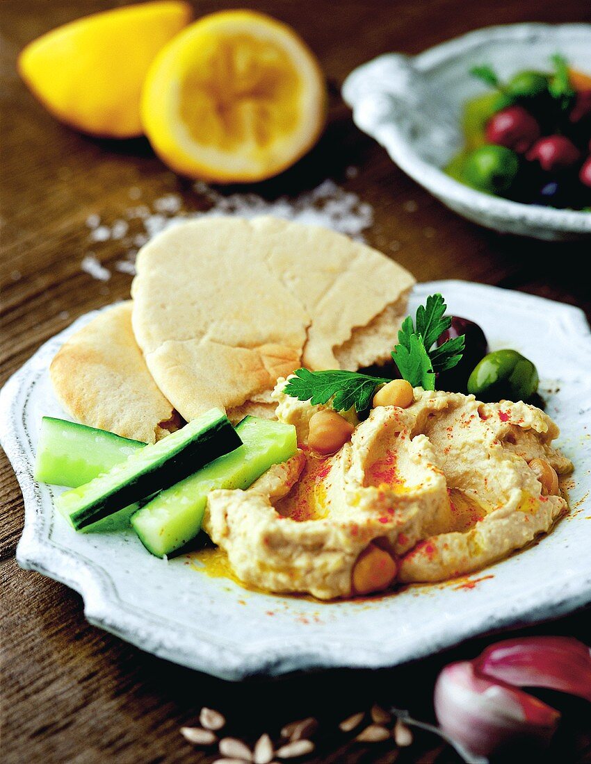 Chick-pea dip (hummus) with flatbread and cucumber