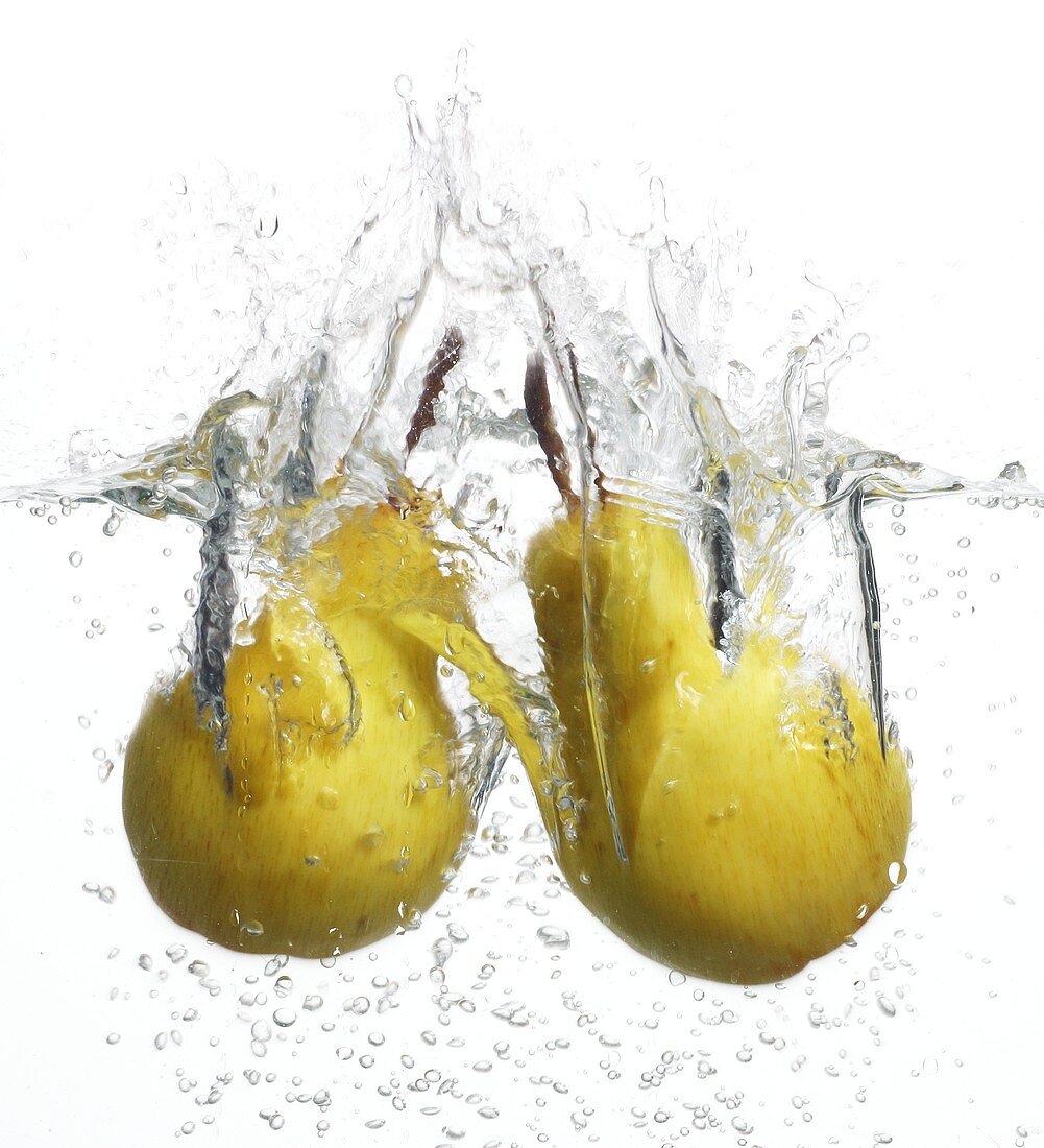 Two pears falling into water