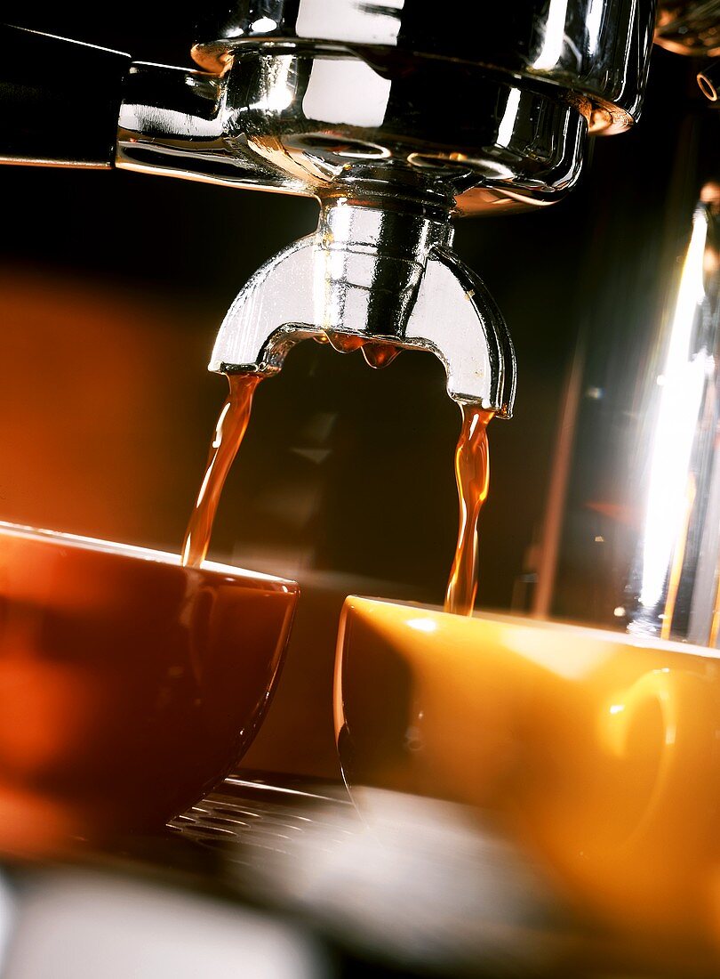 Two cups under a coffee machine