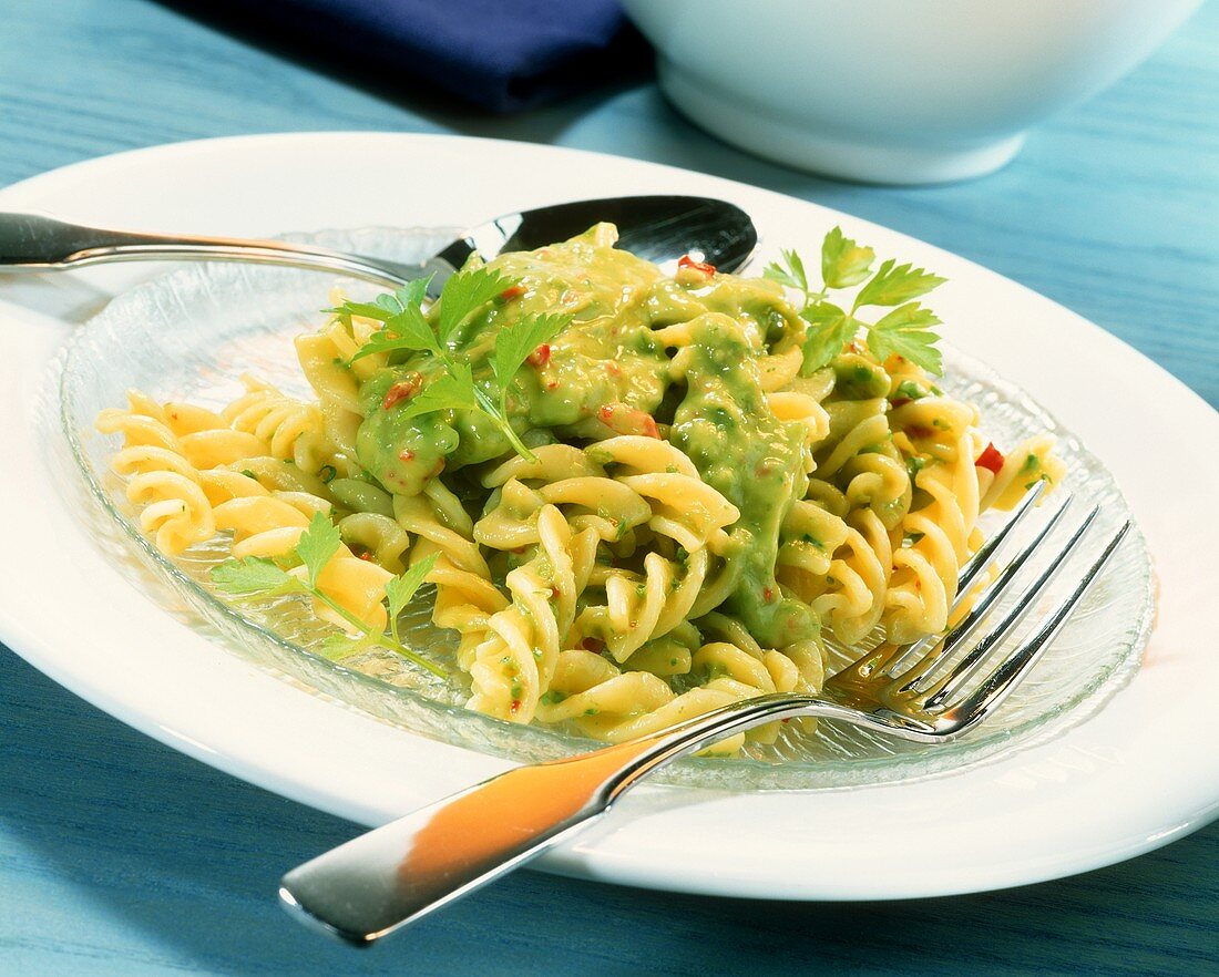 Fusilli with avocado sauce and coriander leaves