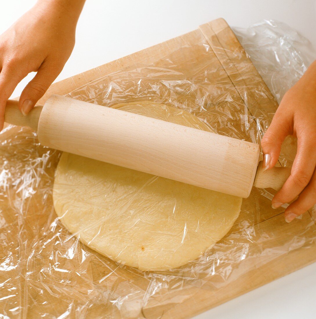 Rolling out pastry between clingfilm