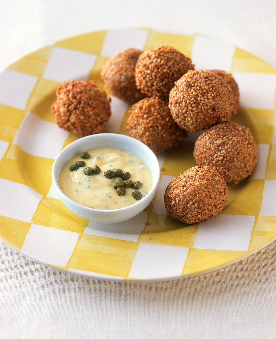 Deep-fried fish balls in batter with caper and mustard sauce