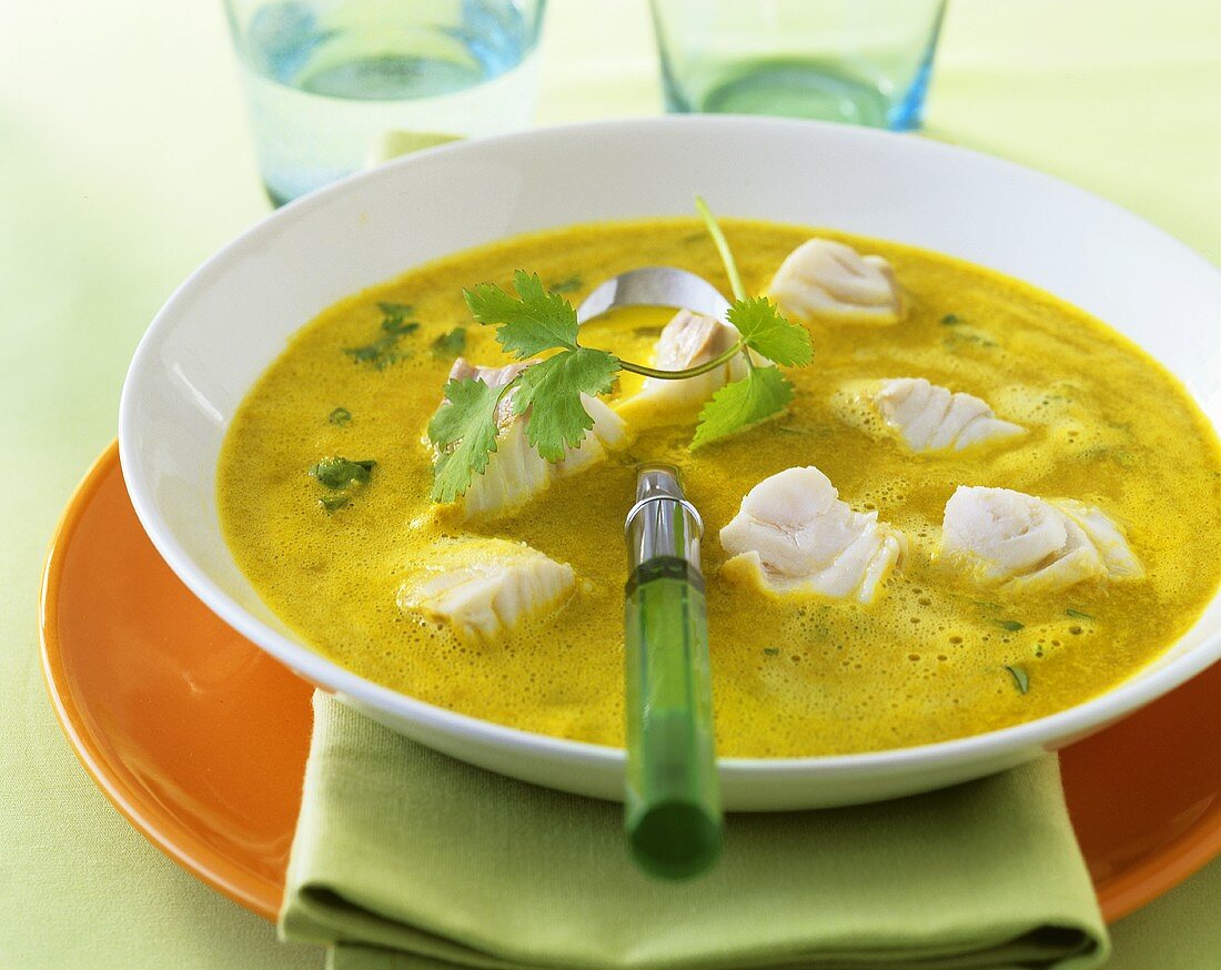 Exotic fish soup with curry and coriander leaves