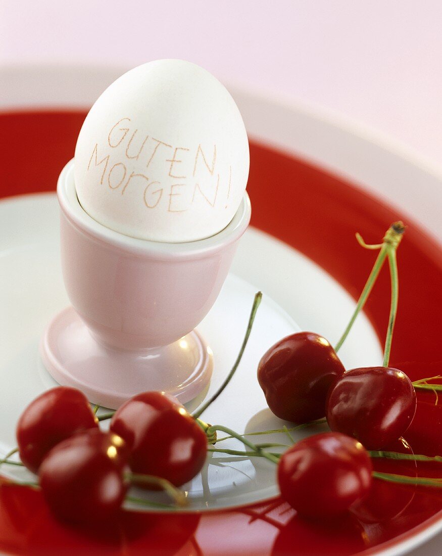 Breakfast egg with words 'Good morning' (in German) & cherries