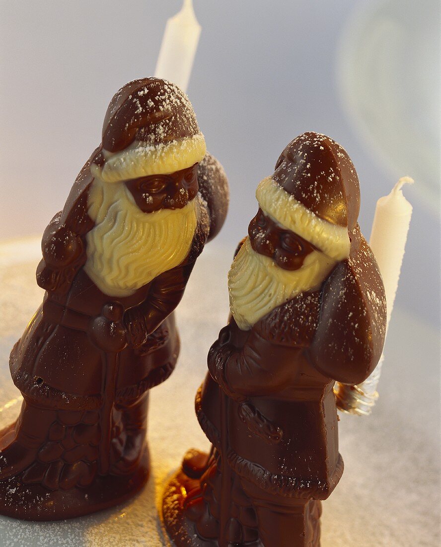 Chocolate Father Christmases, decorated with candle