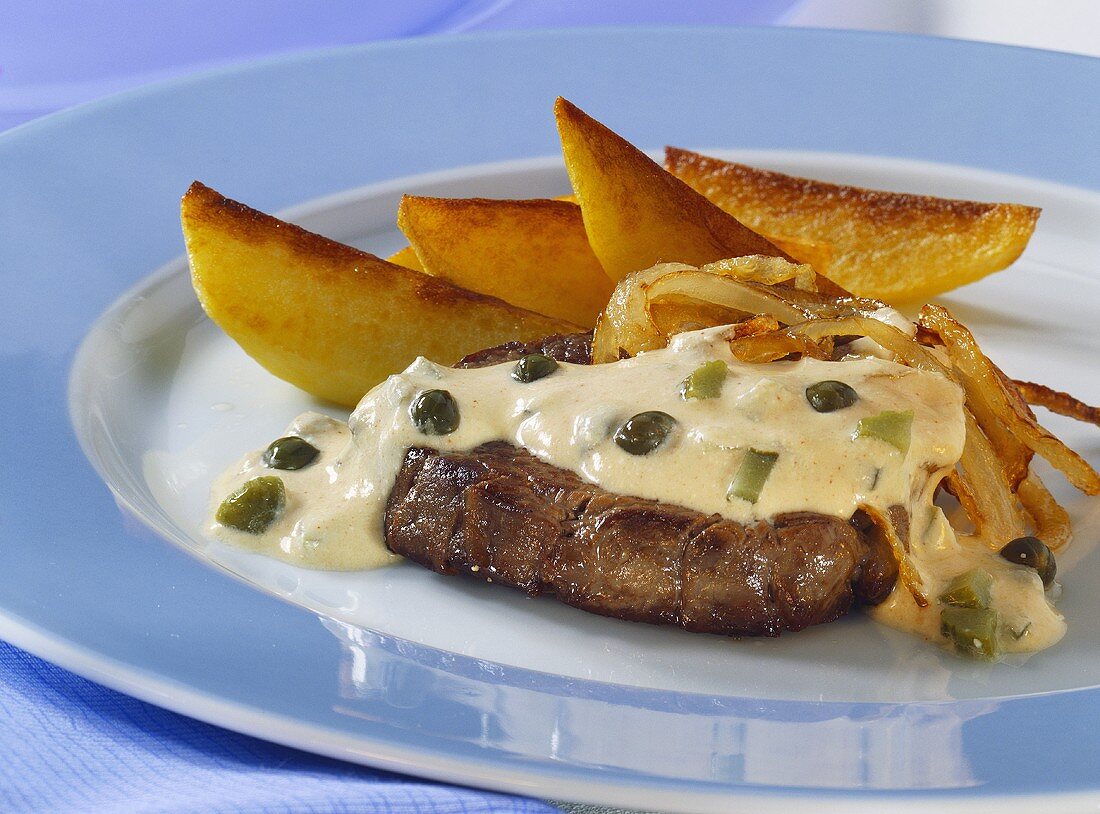 Steak and onions with caper sauce and fried potatoes
