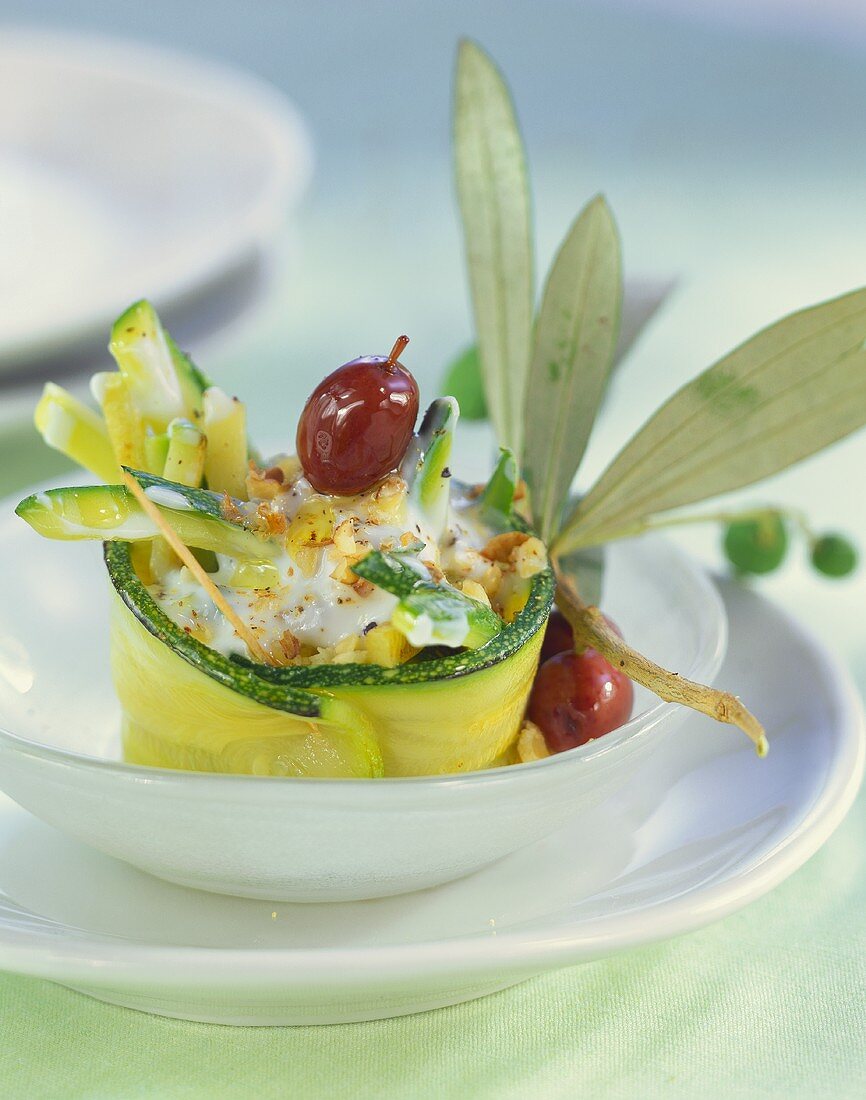 Courgettes rolls with yoghurt, nuts and olives
