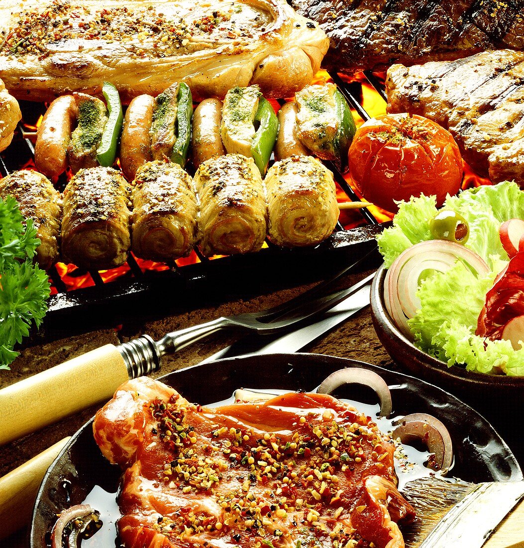 Various barbecue foods in marinade and on barbecue