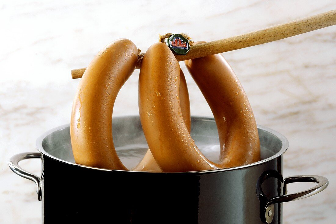Lifting sausage out of the pan