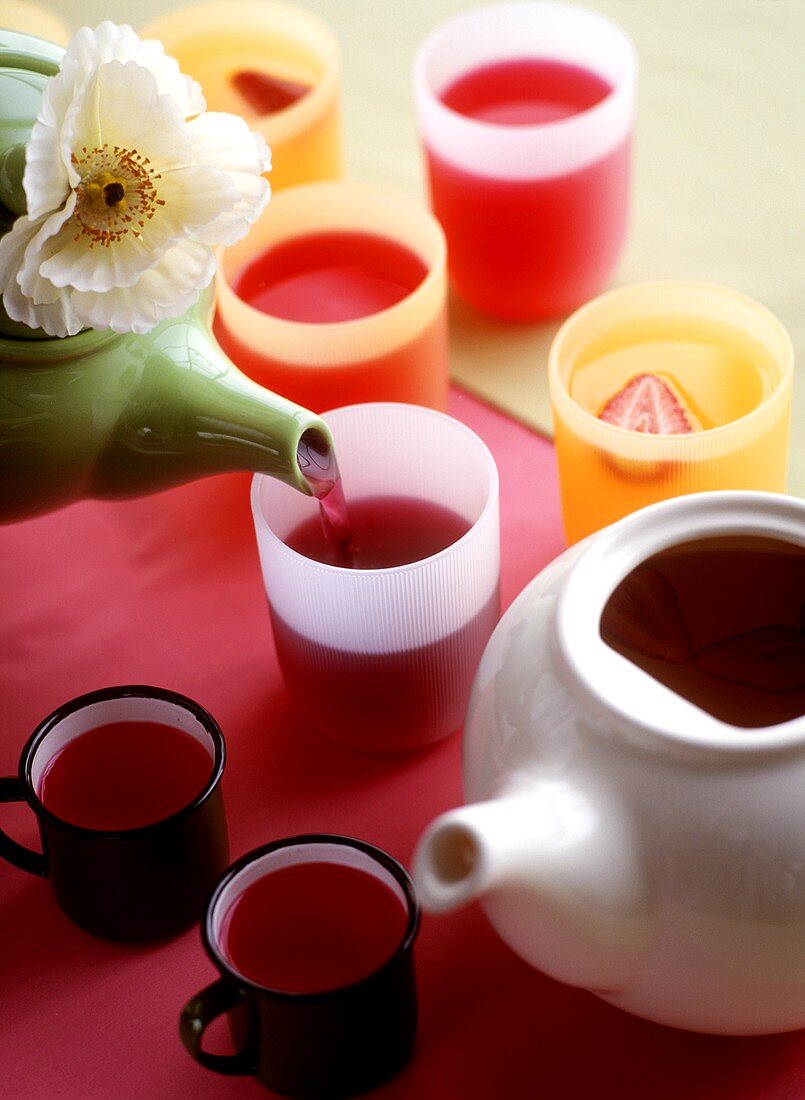 Fruit tea in cups and mugs