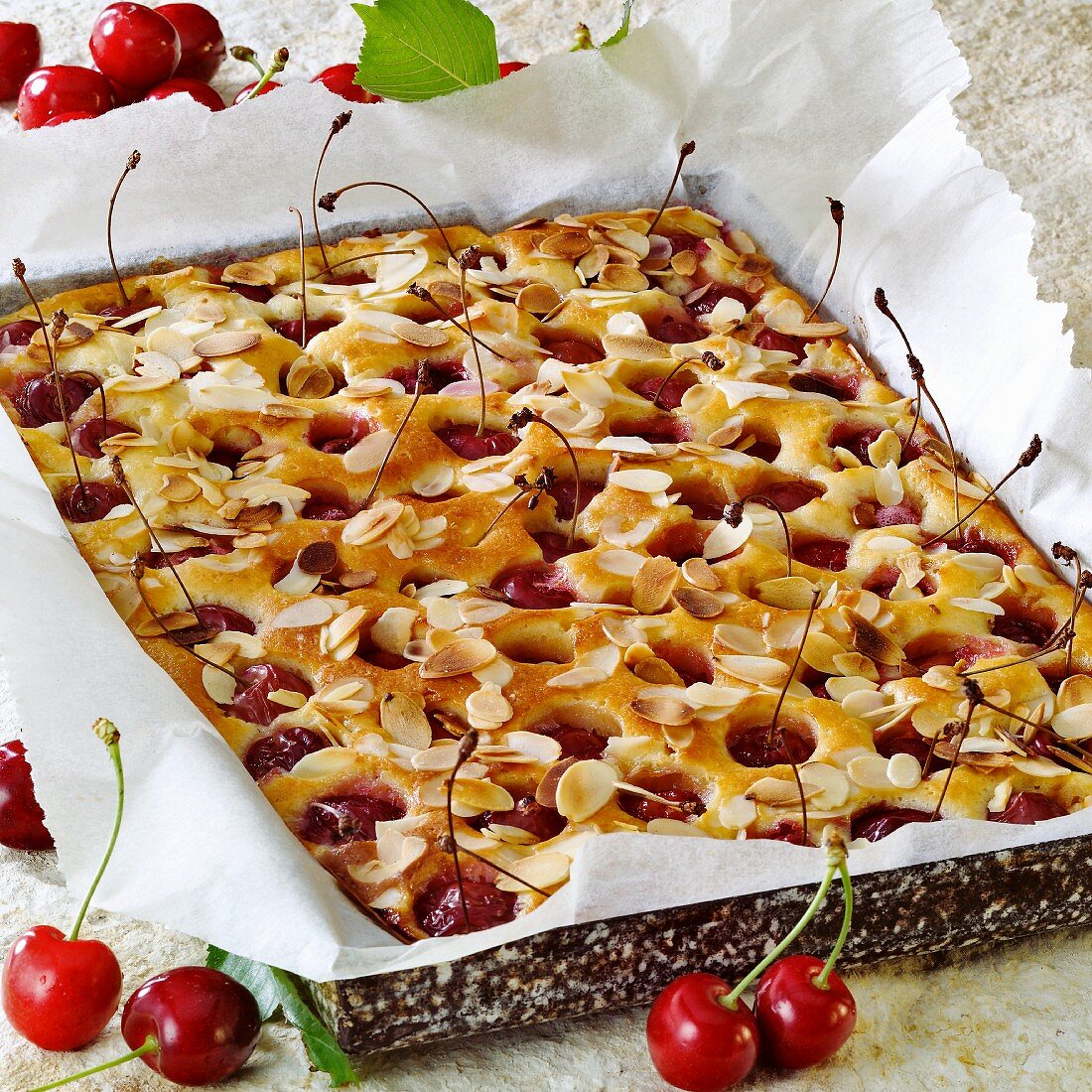 Tray-baked cake with sweet cherries and almonds