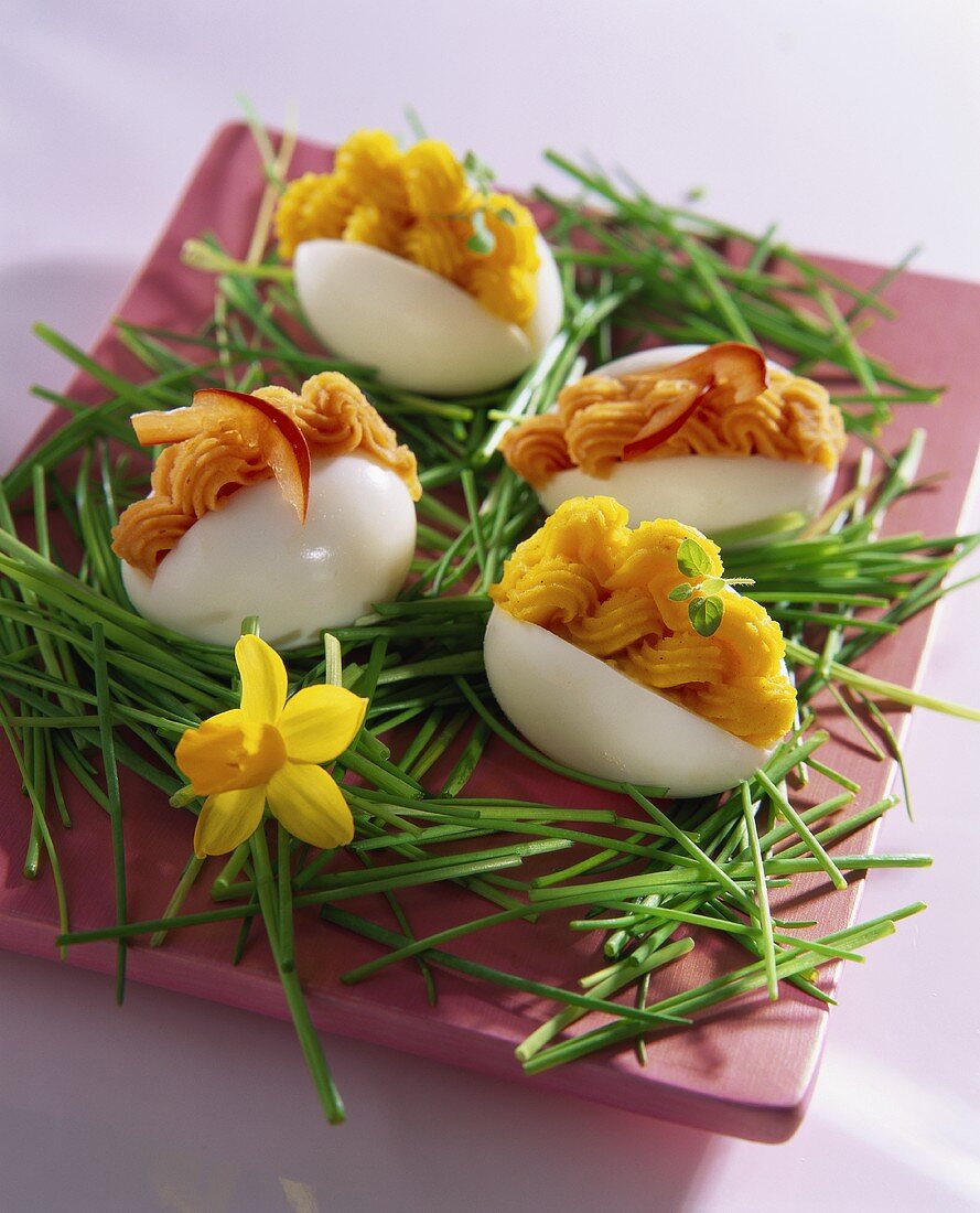 Eggs filled with salmon cream and garnished with chives
