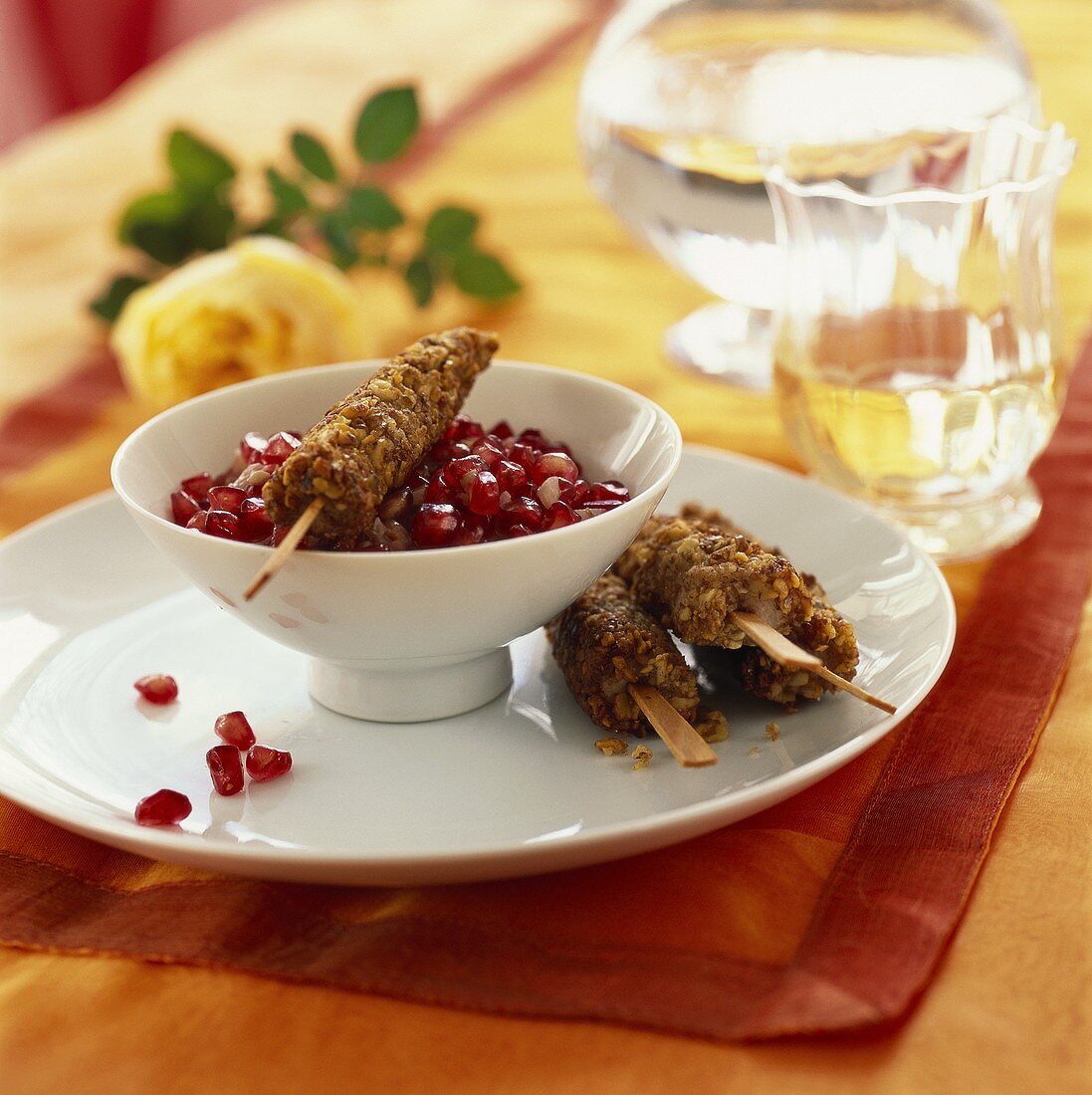 Chicken breast kebabs with nut crust and pomegranate sauce