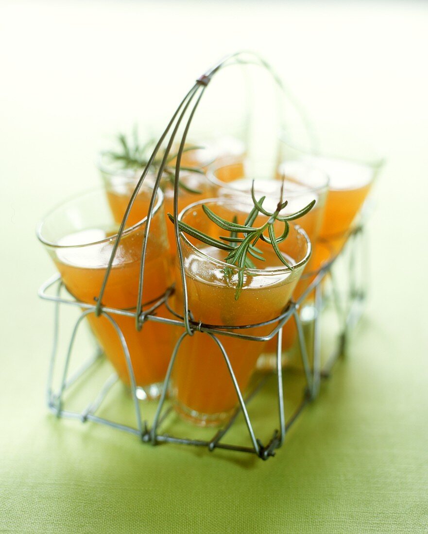 Iced rooibos tea with orange juice & rosemary in bottle basket