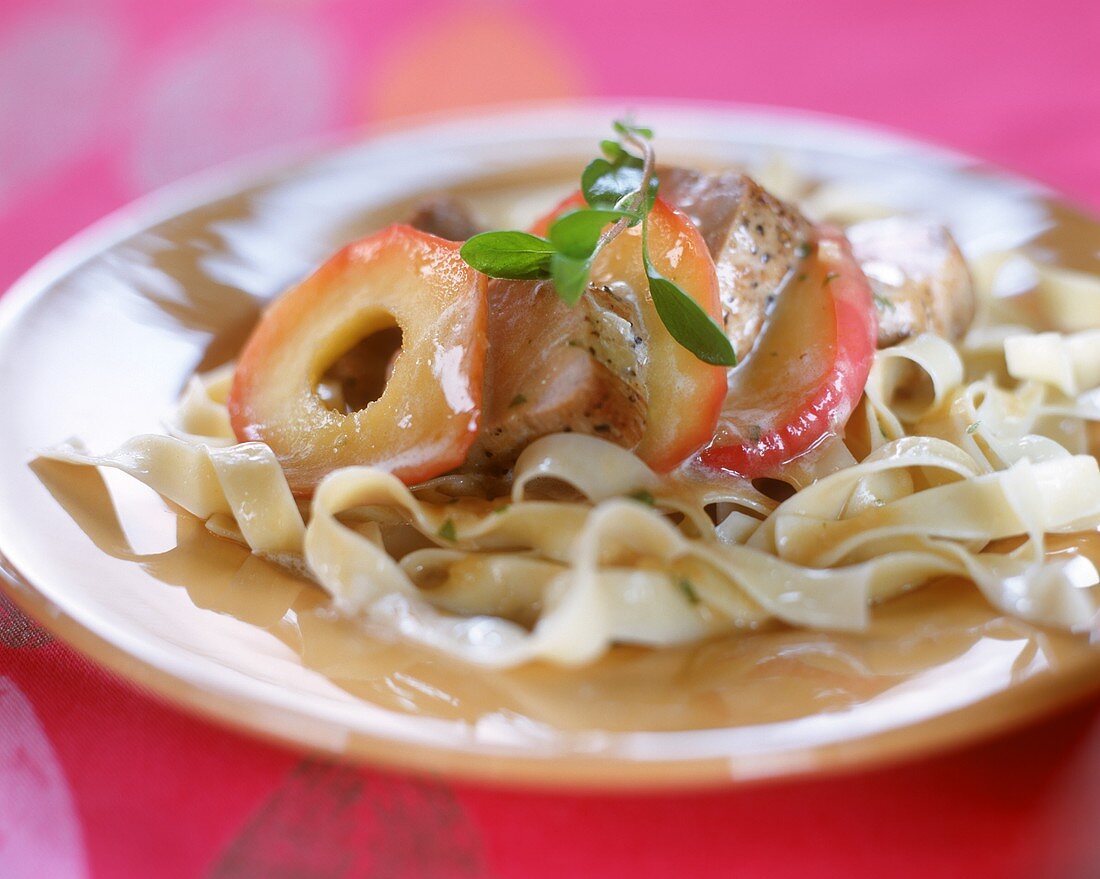 Pork fillet with apple slices and ribbon pasta