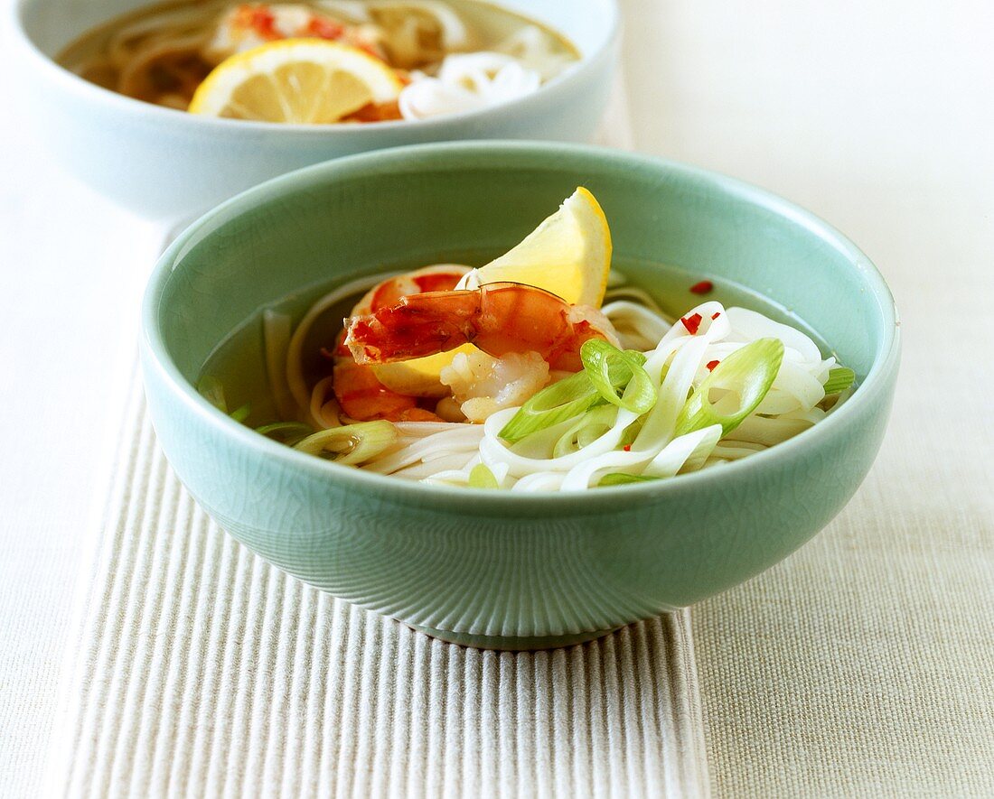 Asian rice noodle soup with spring onions and shrimps
