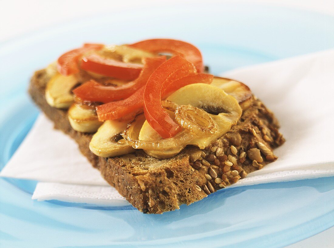 Slice of wholemeal toast with mushrooms and peppers
