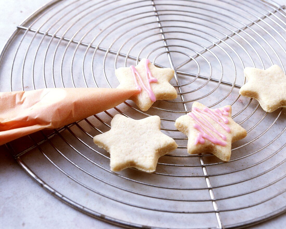 Decorating star biscuits with piping bag