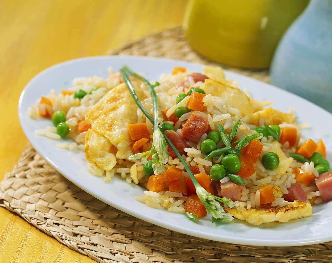 Fried rice with ham, carrots, peas and egg