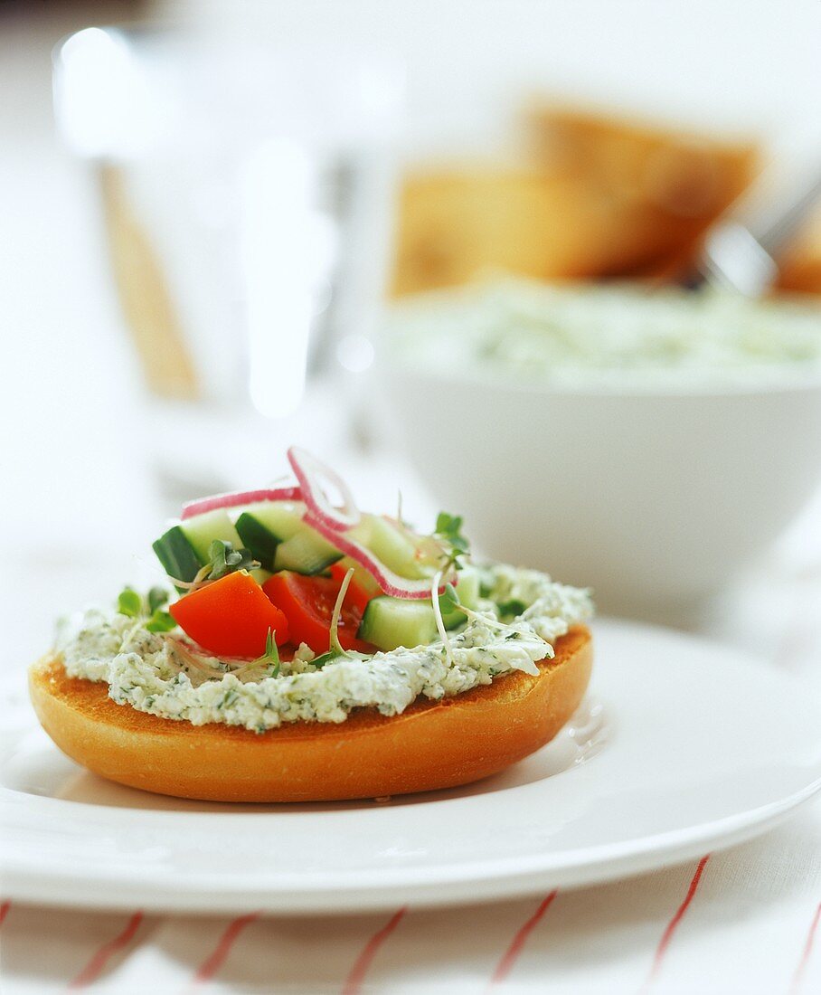 Toasted roll with herb soft cheese and vegetable garnish