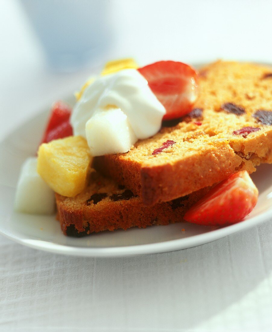 Zwei Scheiben Sandkuchen mit Trockenfrüchten, frische Früchte