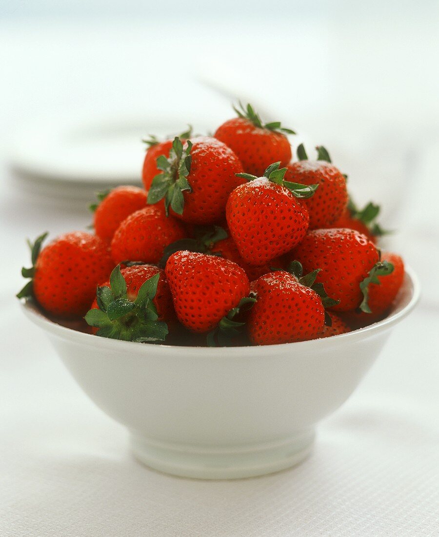 Fresh strawberries in a white bowl