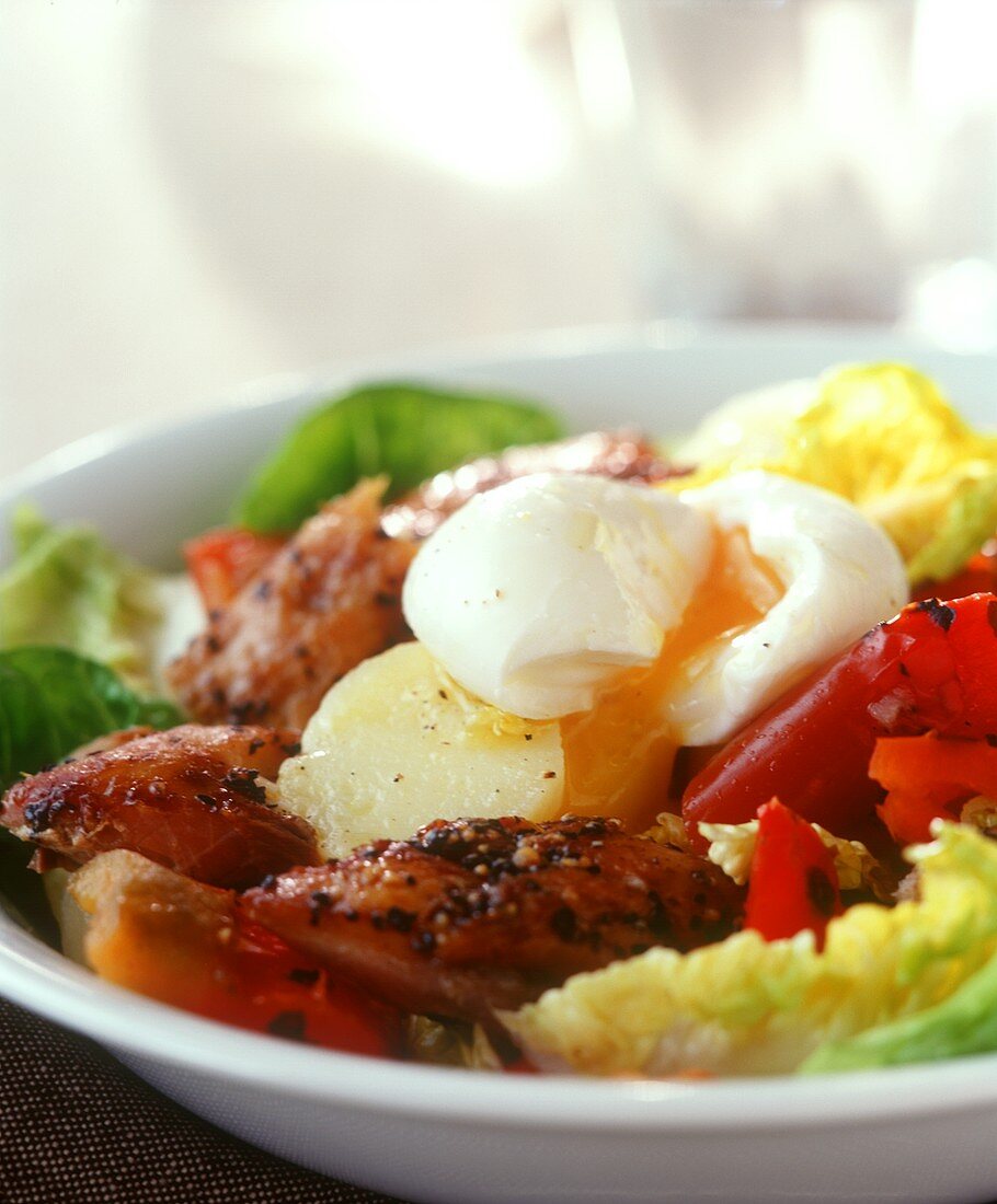 Salad with smoked fish and poached egg