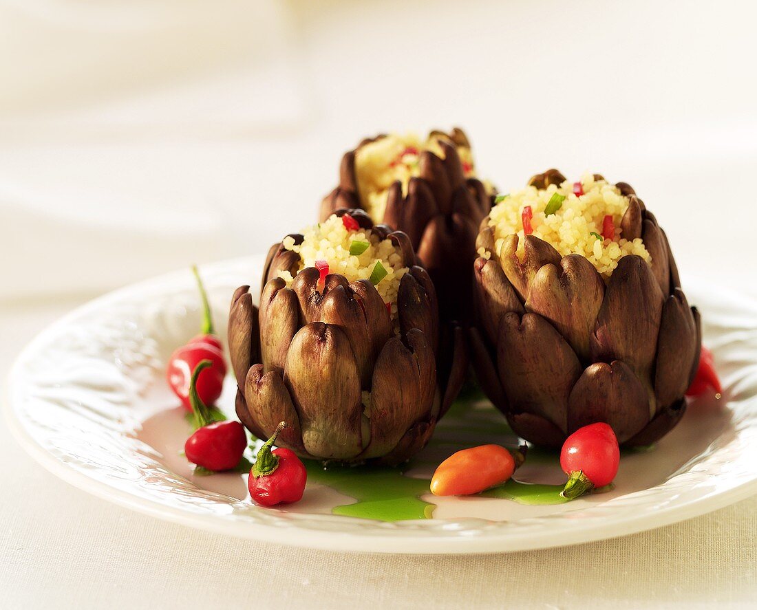 Artichokes stuffed with couscous; small peppers