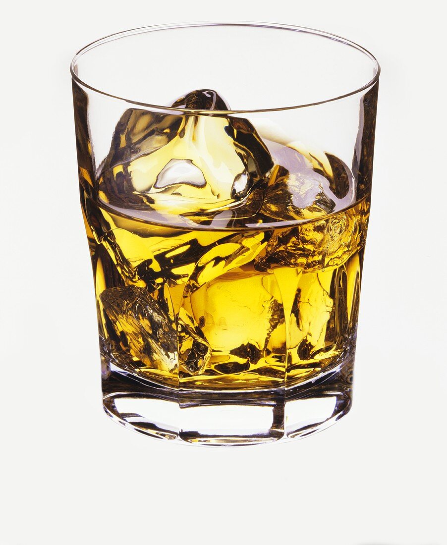 Whisky in glass with ice cubes