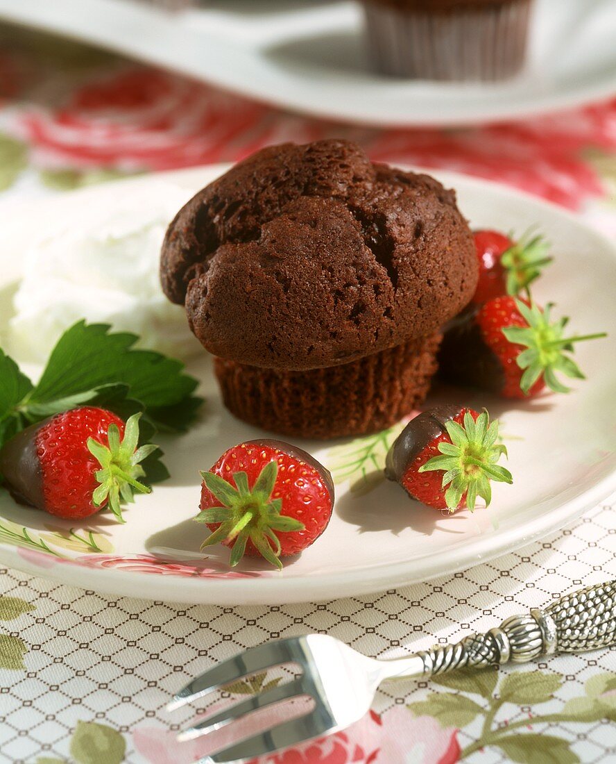 Schokomuffin und frische Erdbeeren, in Schokolade getaucht