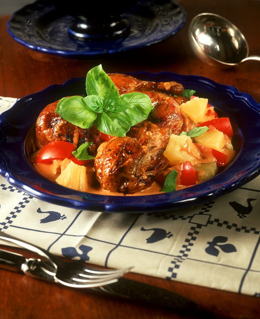 Glazed duck in red curry sauce with pineapple and tomato