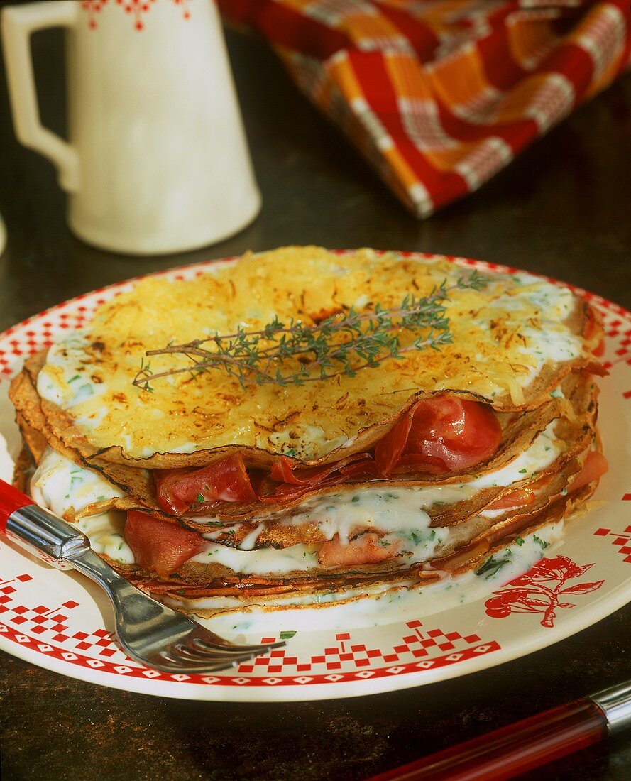 Pile of pancakes with cheese & ham & toasted cheese topping