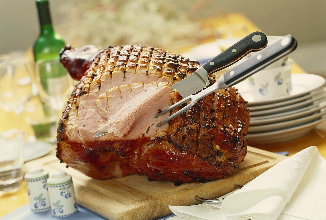Roast ham studded with cloves for picnic