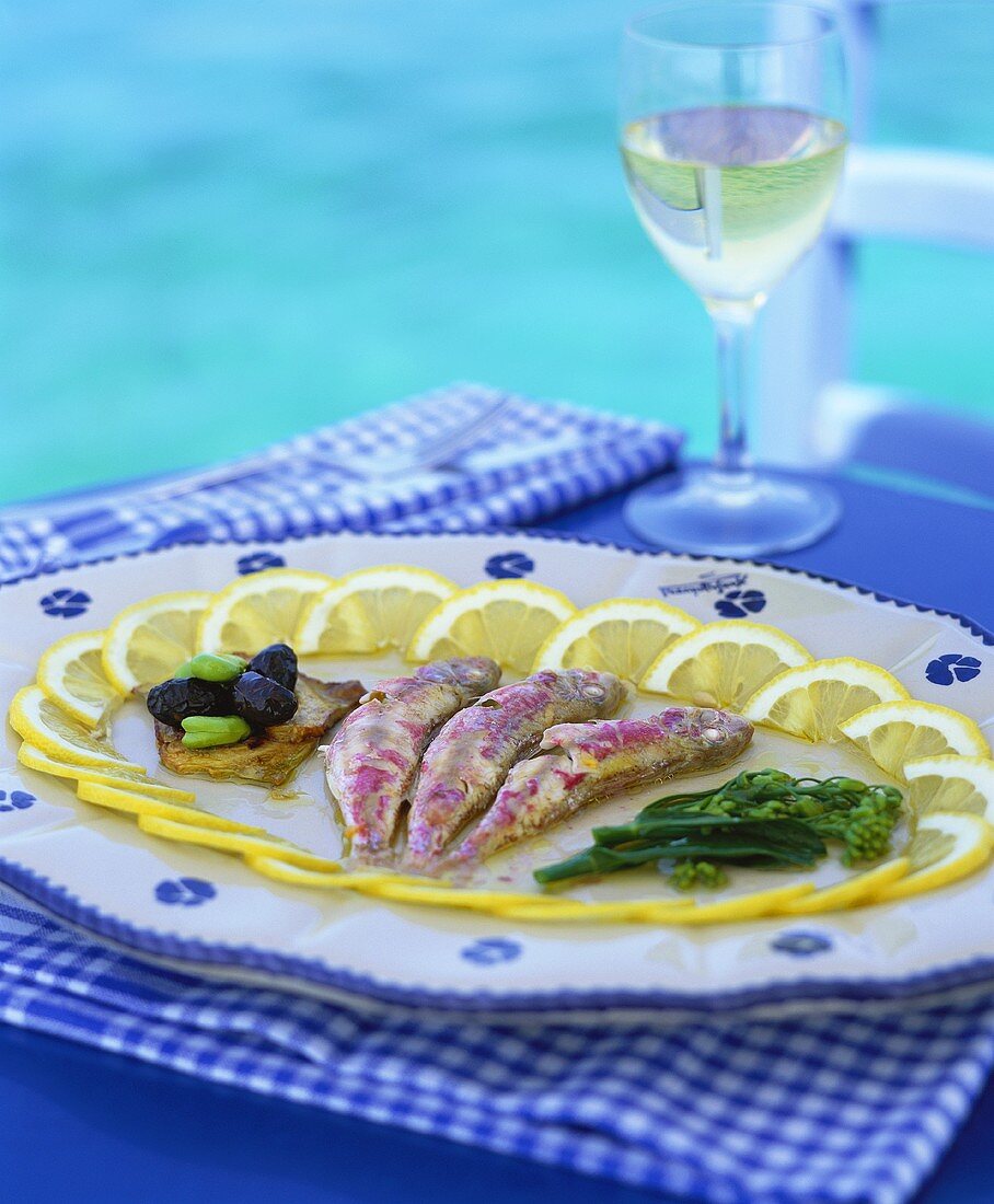 Marinated sardines and glass of white wine (Greece)