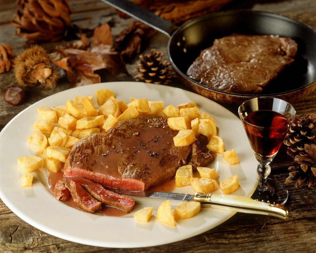 Beef steaks with bordelaise sauce and baked potatoes