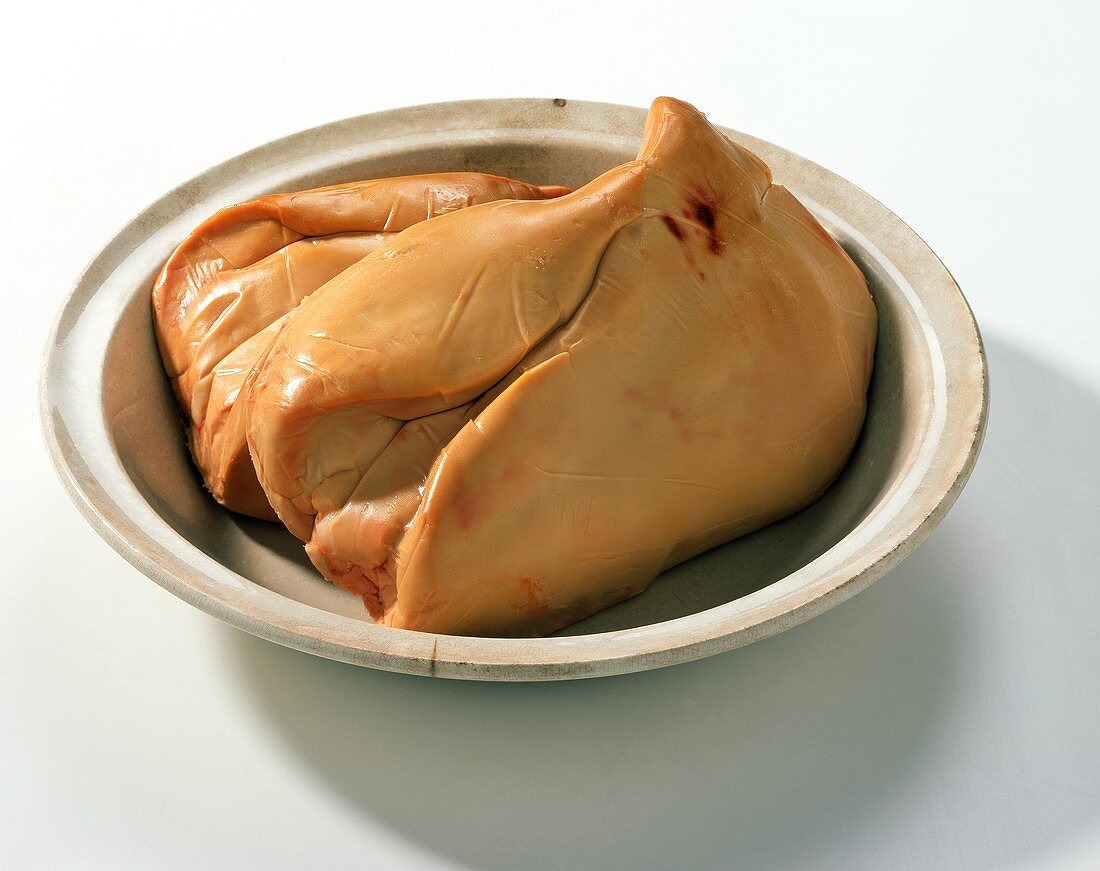 Whole goose liver in a ceramic bowl