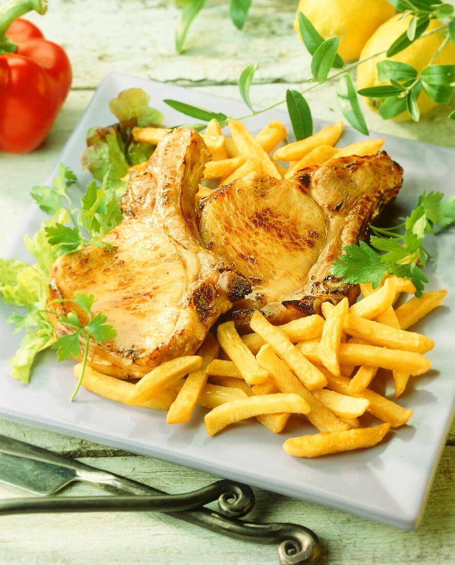 Gebratene Schweinekoteletts mit Pommes Frites