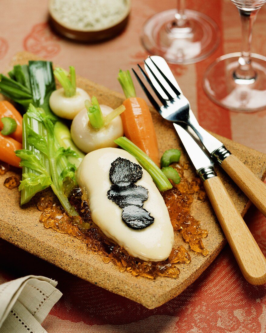 Cheese-coated chicken breast with truffles on aspic