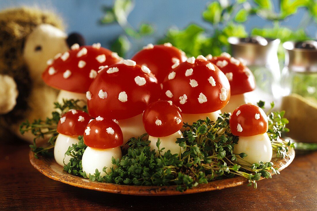 'Fly agarics' made from boiled eggs & tomatoes on bed of cress