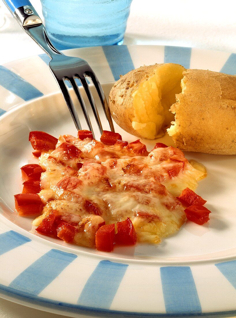 Boiled potatoes in bowl with cheese and peppers