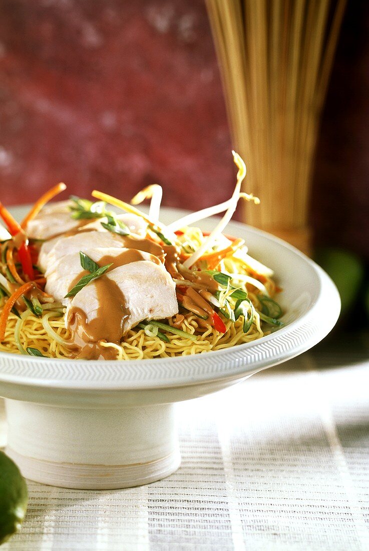 Chicken breast with peanut sauce on egg noodles