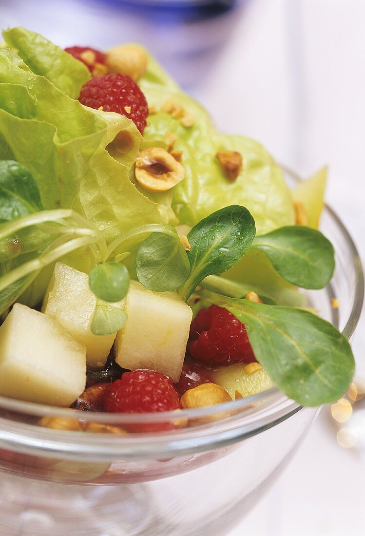 Mixed salad leaves with fresh fruit and nuts