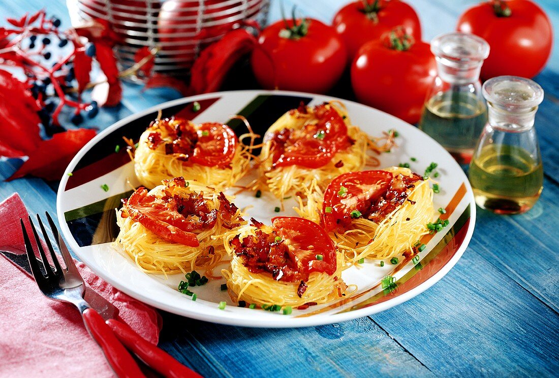 Baked pasta nests with ham and tomato filling