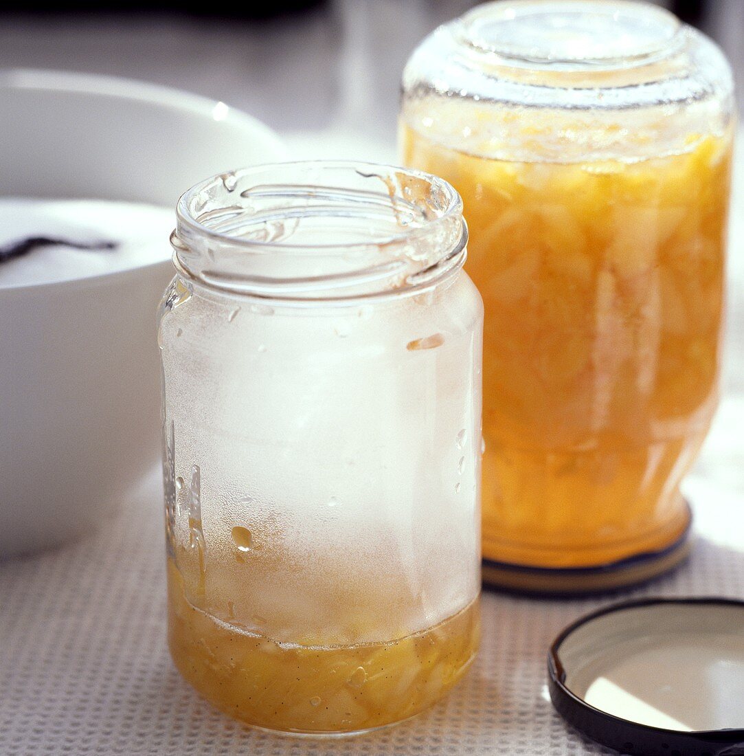 Pouring peach and pineapple jam into jars