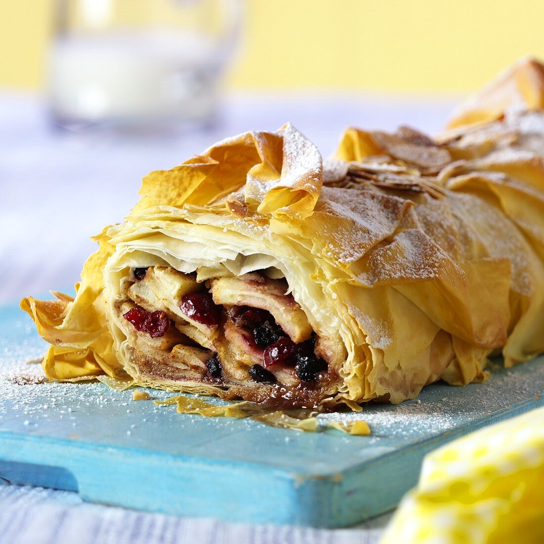 Sweet strudel with fruity filling, a piece cut