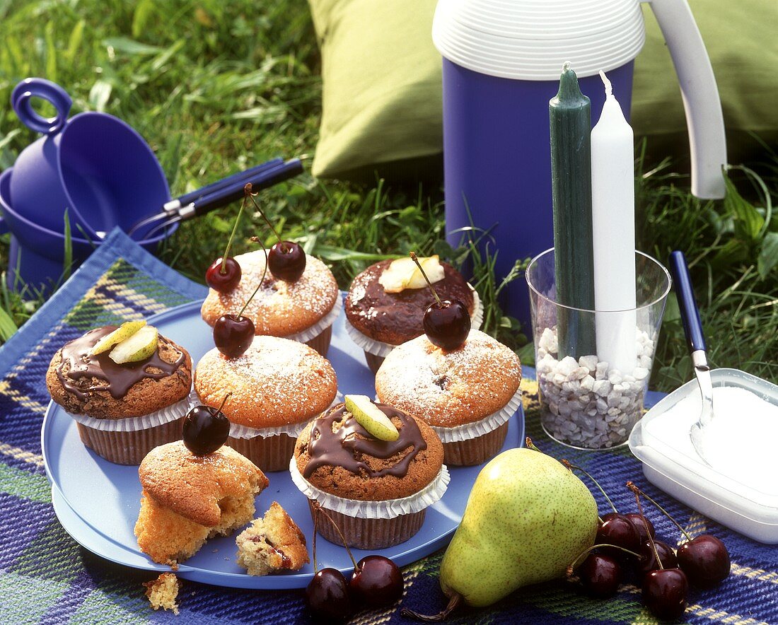 Cherry and pear muffins on a picnic cloth